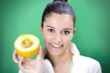 girl holding melon in her hands